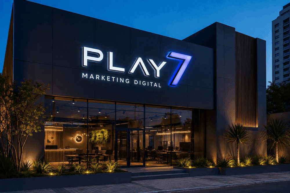 Fachada da Play7 Marketing Digital à noite, com letras caixa iluminadas